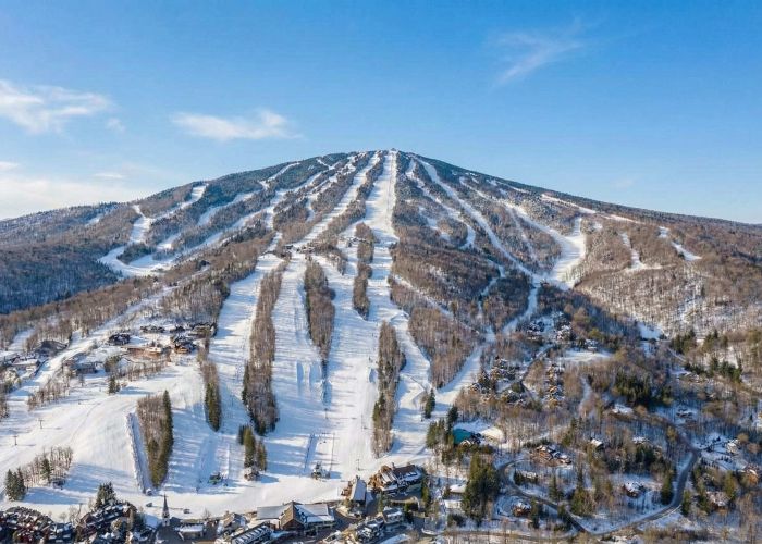 Snow-covered trees and mountain peaks at Stratton Mountain in Vermont on a clear winter day