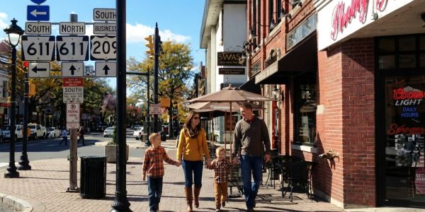 Family walking together through a charming small-town street in the Pocono Mountains.