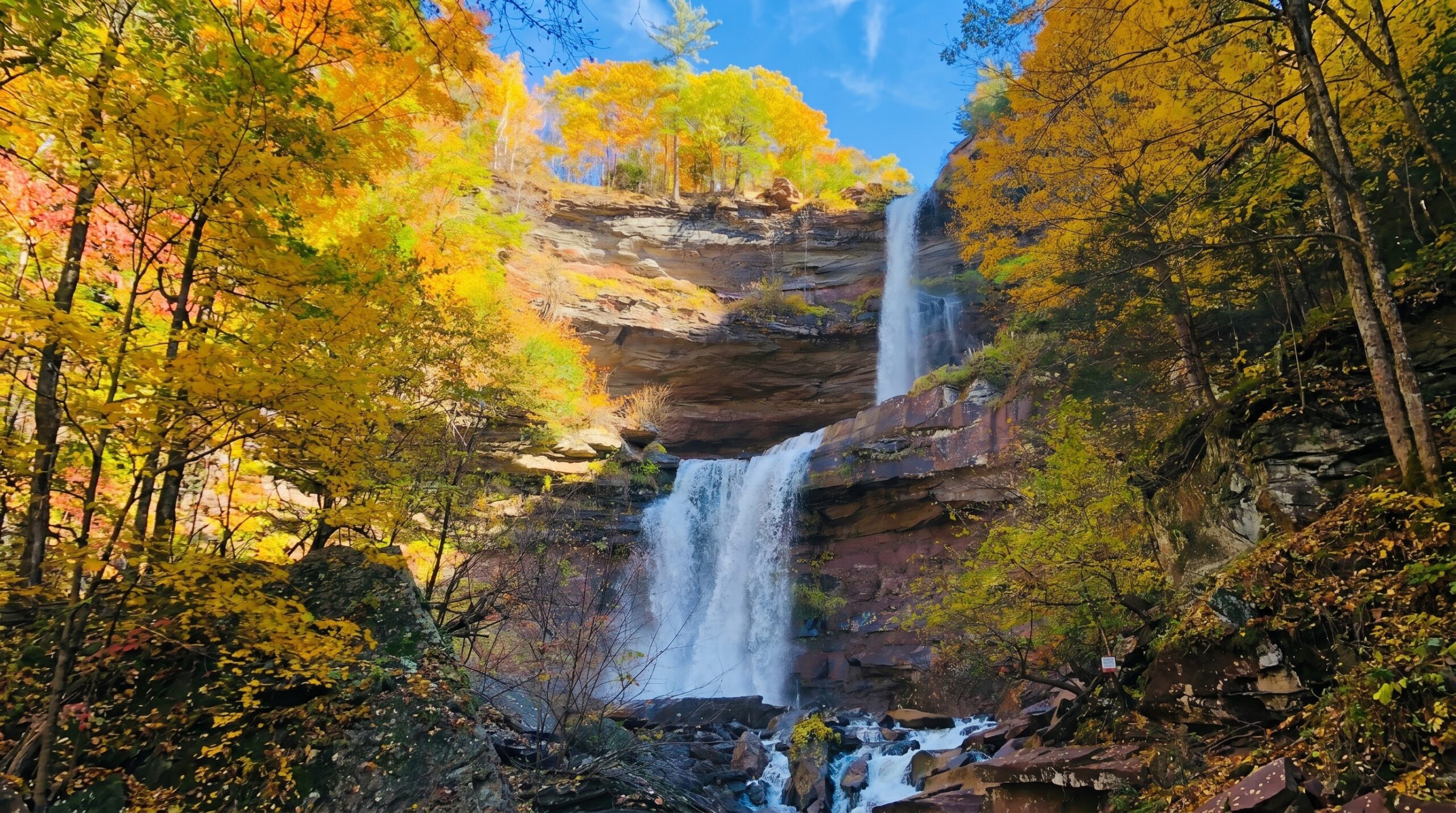 Hiker on a Catskills trail near Fleischmanns with waterfall views.